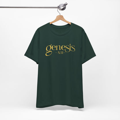 A dark forest green t-shirt hanging on a wooden hanger from a metal clothing rack, featuring the text 'genesis XII' printed in a gold cursive font on the chest.